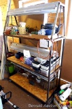 Sturdy shelf unit is set up for starting plants with three light fixtures attached at each shelf.
