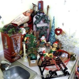 Christmas decorations including glass hurricane for candles; sparkly tree; glittery sled wall or