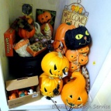 Halloween and fall decorations including lighted pumpkins, wall hangings, plastic cauldron, acrylic