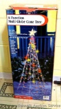 Indoor/outdoor 8 function multi-globe cone tree stand 7' tall, works. Comes in original box.