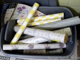 Four new rolls of cheery yellow and white checked contact paper; plus a variety of wallpaper and