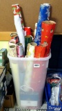 Wrapping paper tote filled with a variety of papers. Tote is missing top.