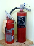 Ansul Sentry and Super Pro fire extinguishers. Both read 'Charged'. Taller is 17