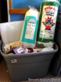 18 gallon tote filled with batting, material, velcro, bias tape, more. Three rolls of batting appear