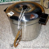 Stovetop juice maker pot has strainer top, lid, tube for juice to drain off. Pot stands 12