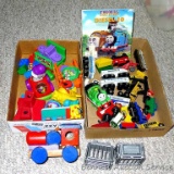 Train sections that connect with magnets; wooden train parts; several toddler and baby toys and