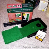 Club Champ Automatic Putting System for indoor practice and a box full of golf balls.
