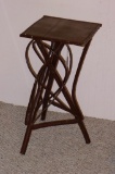 Interesting stand for plant display or side table is made from wooden branches and smaller stems