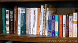 Shelf of books with a variety of subjects including health and healing, workshop books, gardening