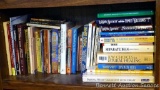 Shelf of books with a variety of subjects including health and healing, home improvement, cooking,