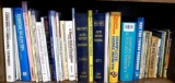 Shelf of books with a variety of subjects including health and healing, furniture projects, auto