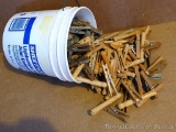 Gallon bucket filled with wooden clothes pins.