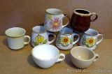 Variety of coffee mugs with 4 matching.