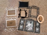 Metal photo displays and frames. Largest frame holds a 5