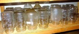 Shelf of quart narrow & wide mouth canning jars with brands Ball, Kerr, Atlas and some with no brand