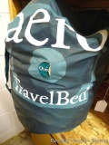 Queen travel bed in storage bag. Vinyl smells new.