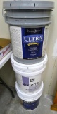 No shipping. Three partial 5 gallon buckets of paints including exterior house paint and textured