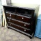 Large wooden 3 drawer dresser with open storage above drawers. Unit measures 47