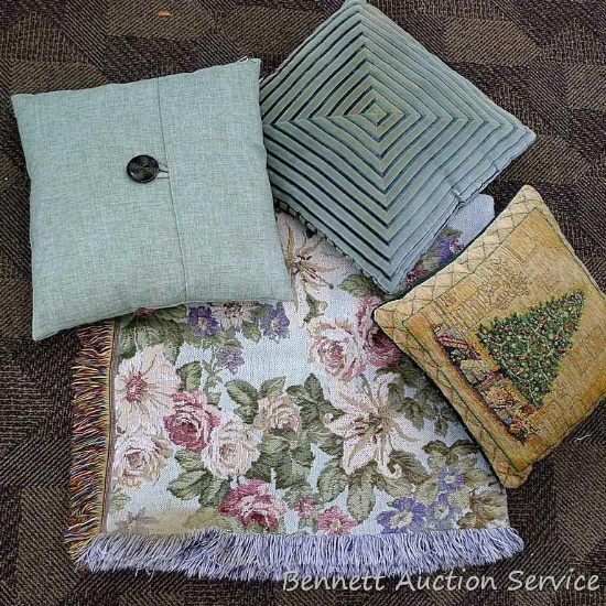 Three complimentary throw pillows and a blanket. Spots noted on s couple of the pillows may come