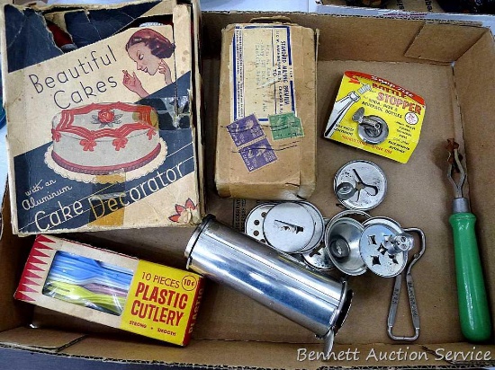 Vintage collection of kitchen utensils including cake decorator, cookie press bottle stopper, pastry