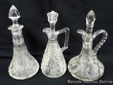 Three glass cruets; largest measures 3-1/2