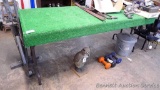 Sturdy folding table. Top is wood, covered with indoor/outdoor rug. Table is 30