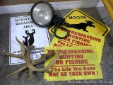 Rattling antlers, Coleman 800,000 candlepower spotlight, No Trespassing and Deer Management signs,