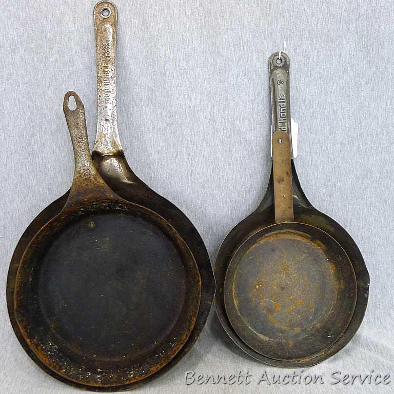 Four stamped steel fry pans. Largest is 22 with