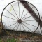 Nearly 4-1/2' diameter steel implement wheel.