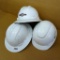 Three adjustable size hard hats.