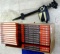 Box of The Practical Handyman's Encyclopedias and a Scarecrow yard sprinkler about 2' long. Books
