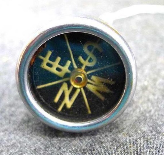 Doxa lapel compass is about 2" long and looks to be fairly accurate.