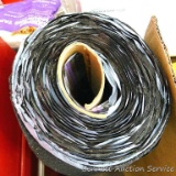 Partial roll of black asphalt role roofing. Roll is 40