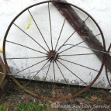 Nearly 4-1/2' diameter steel implement wheel.