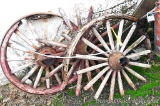 Pieces and parts of three wooden spoked wheels. Most complete piece is 29