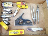Two drawing compasses, cork screw, spark plugs, more.