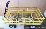 Heavy duty steel Gorilla Cart with hinged side walls. Three tires need air. One tire needs replacing