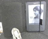 Amazon Kindle tablet reader with black case and cord. Aprox. 5