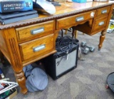 Large, sturdy, beautiful wooden desk, intricate carved detailing on edges and legs. Five drawers