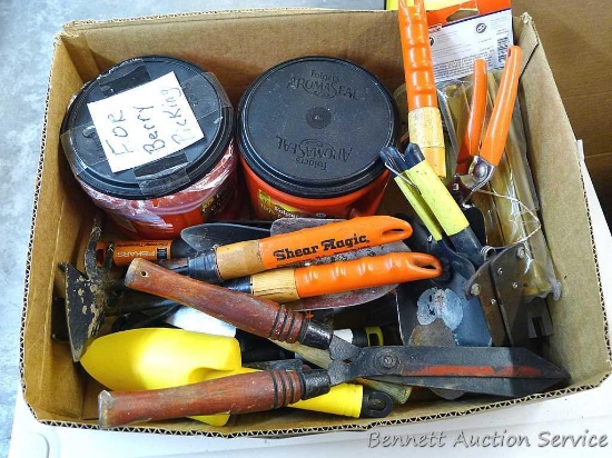 Box of Stanley garden shears, various garden trowels, plastic tent stakes, and more. Box measures