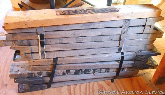 Pair of saw horses with an extra cross board. Legs of sawhorses are about 24" and 28" long. Located