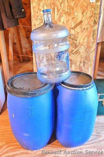 Plastic carboy is about 19" x 10"; Two blue barrels with lids about 13" x 15" x 25" tall.