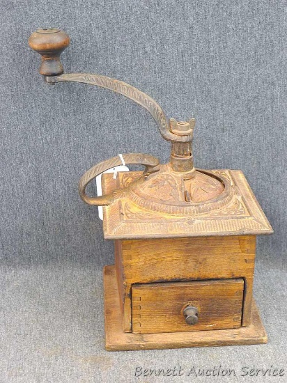 Antique cast iron and wood coffee grinder is about 6" x 6-1/4" x 11" over top handle. Neat piece