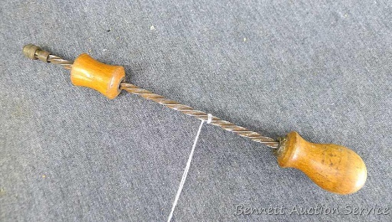 Vintage spiral shaft push drill is of maple iron and brass construction over 9" long and works well.