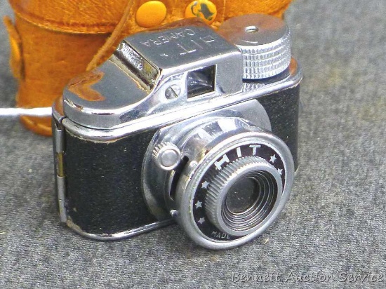 Adorable tiny HIT camera with leather case shutter functions. Noted some scuffs by hinge, but in