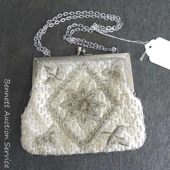 Beaded fabric clutch with chain handles. Clutch measures approx.. 6" x 7".