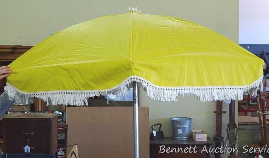 Beautiful vintage table umbrella with floral lining which measures approx.. 71" wide when opened and