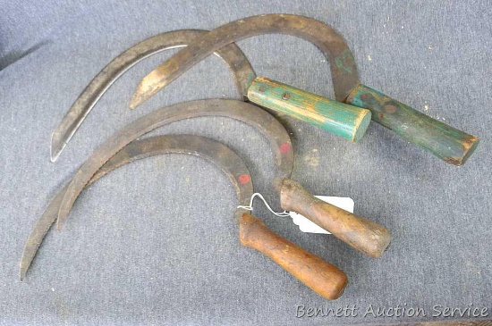 Set of four antique sickles. Two have serrated edges. Sickles measure approx.. 14" x 10"