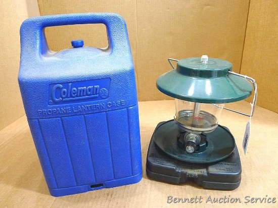 Coleman lantern with case has a Coleman globe in good condition. Metal base near bottle attachment