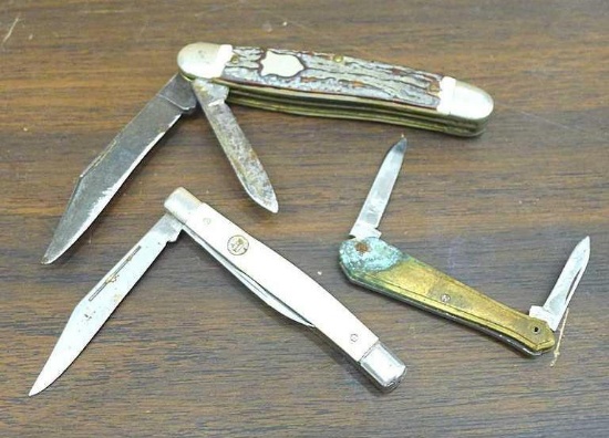 Camillus and other pocket knives. Smallest has metal handle slabs. Longest about 3-1/4" over body.